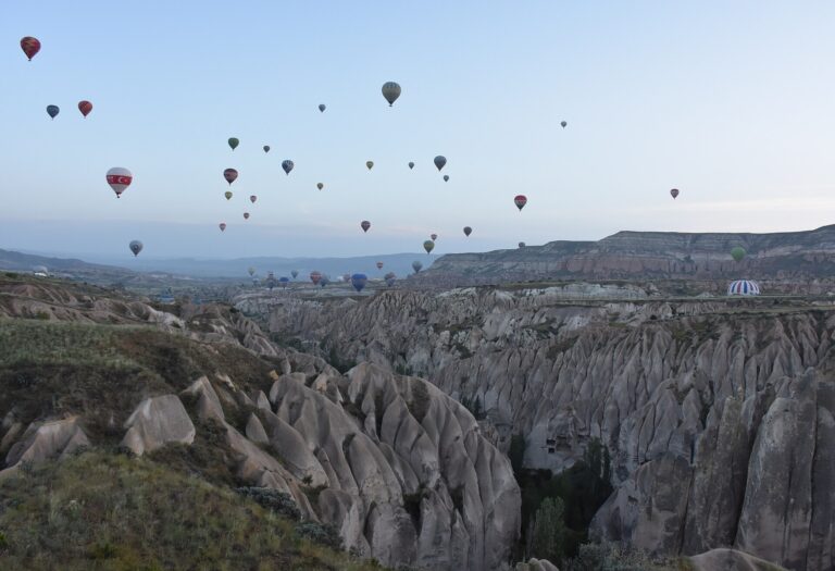 Hot air balloons rising over the valleys near Goreme in Cappadocia at dawn
