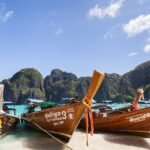 Maya Bay on Phi Phi Leh island in Thailand with white sand and limestone cliffs