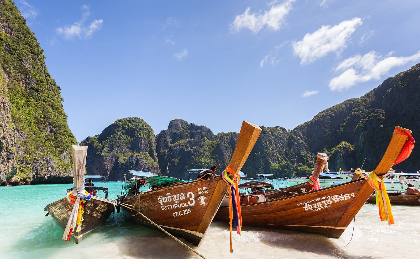 Maya Bay on Phi Phi Leh island in Thailand with white sand and limestone cliffs