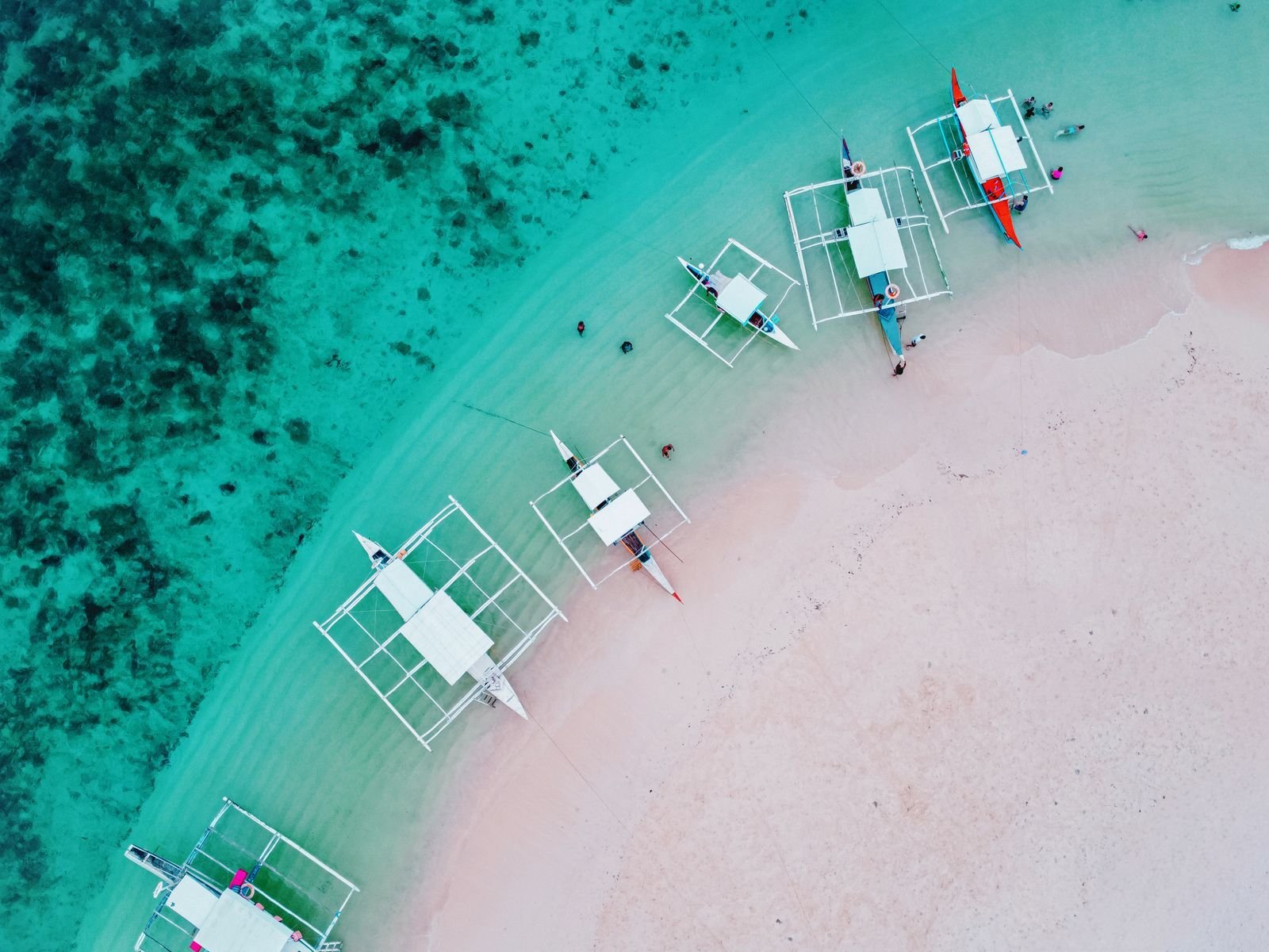 Traditional boats on clear water off Siargao