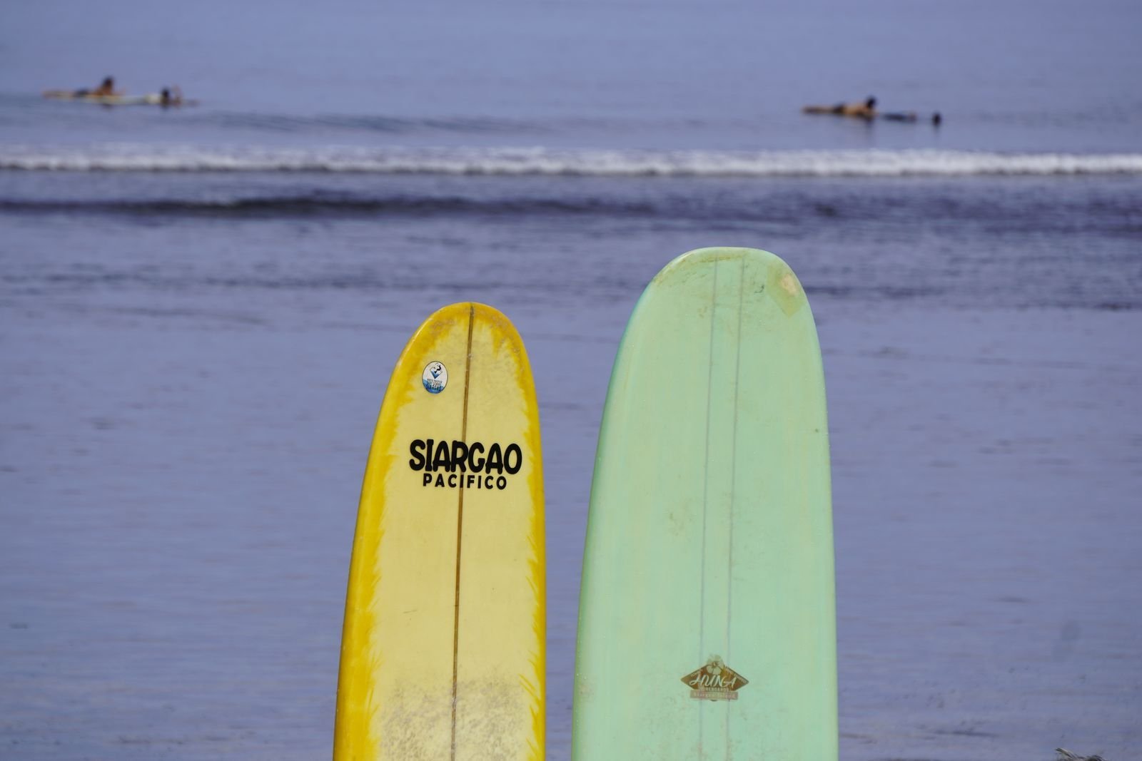 Siargao travel guide with surfboards on an island beach
