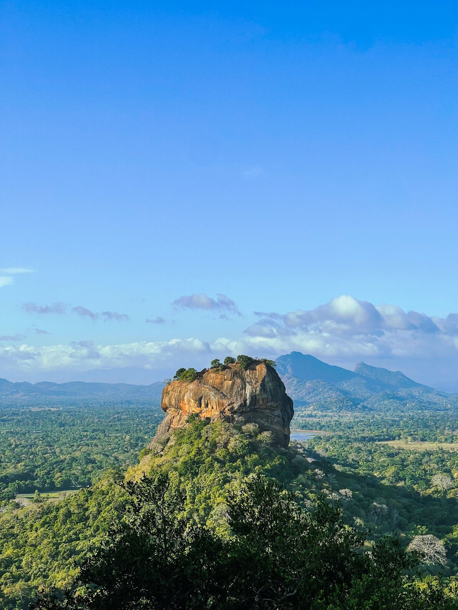Sigiriya Rock Fortress rising above green forest in Sri Lanka