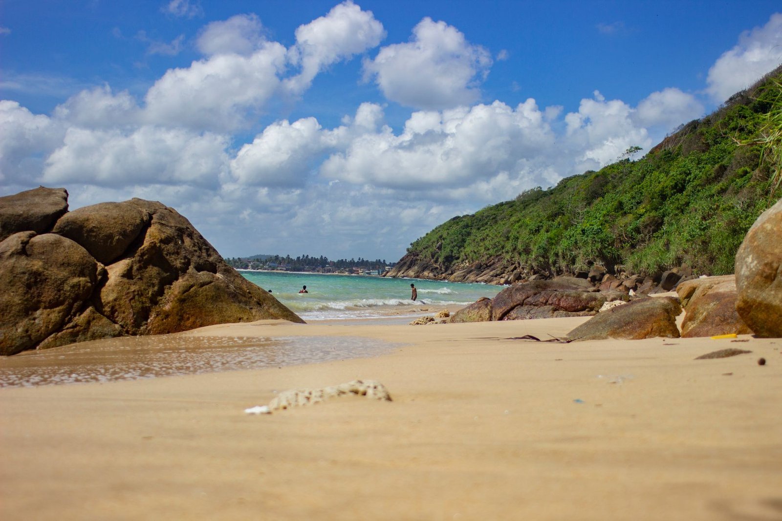 Sandy Unawatuna Beach and rocky coast in Sri Lanka